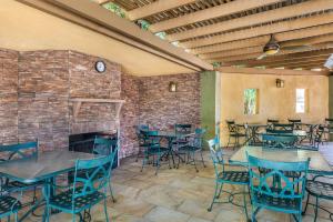 a restaurant with tables and chairs and a brick wall at Best Western Inn at Palm Springs in Palm Springs