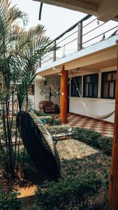 a house with a hammock in front of it at Complejo Don Pascual in San Pedro La Laguna