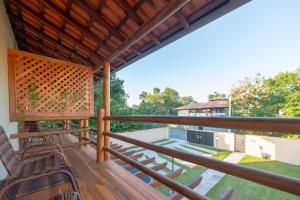 a view from the deck of a house with chairs at Lofts Corujinha Paraty in Paraty