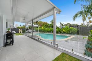 an external view of a house with a swimming pool at Aloka By Khove in Gold Coast