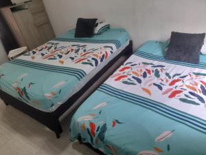two beds with fish printed on them in a room at apartamento tercer piso cali in Cali
