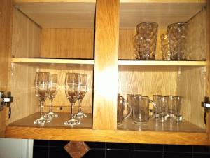 a row of wine glasses sitting on a shelf at LittleLux Living in George Hill