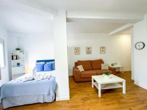 a living room with a bed and a couch at Carvajal Beach and Pool ComoTuCasa in Fuengirola