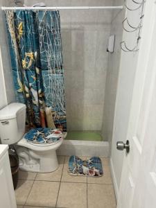 a bathroom with a toilet and a shower curtain at B2 Best Value on Private Bedroom with Private Bathroom in Little Havana, Miami in Miami