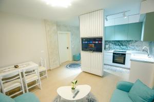 a kitchen with blue cabinets and a table in a room at Velipoja Green Home in Velipojë