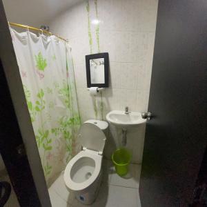 a bathroom with a toilet and a sink at Hostal Jireth in Floridablanca