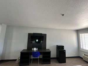 a room with a desk and a tv on a wall at Motel 6-Lebec, CA in Lebec