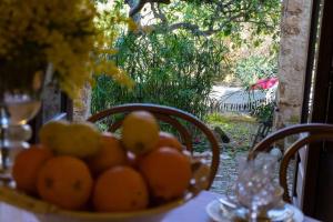 a bowl of oranges sitting on a table with a table cloth at Casa di Nonna Maria in Pietraperzia