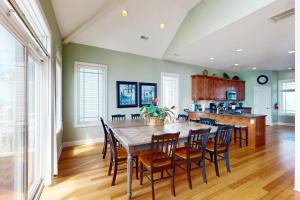 a kitchen and dining room with a table and chairs at NTB104 Seas Escape in North Topsail Beach