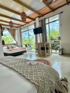 a living room with a bed and a large window at Ritacuba House Boutique in Santa Marta
