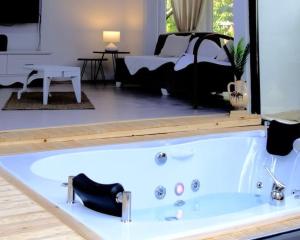 a bath tub in a room with a bed at İZNİK Lake House in İznik