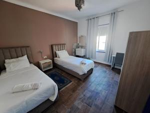 a hotel room with two beds and a window at El Muniria in Tangier