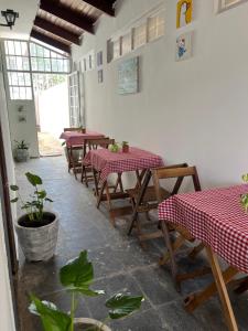 un restaurante con mesas con cuadros rojos y blancos en Quarto Sr. Formiga Ceres0024 en Cuiabá