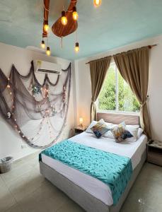 a bedroom with a large bed with a large window at Ritacuba House Boutique in Santa Marta