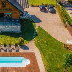 an aerial view of a yard with chairs and a pool at Family friendly house with a swimming pool Ogulin, Gorski kotar - 22843 in Ogulin