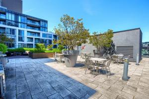 a patio with tables and chairs and a building at Condo in the heart of Downtown Toronto! in Toronto