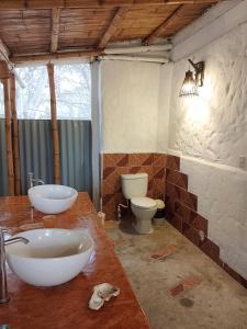 ein Badezimmer mit 2 Waschbecken und 2 WCs in der Unterkunft Fundo Matufa Mancora in Canoas De Punta Sal