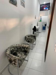 a waiting room with two chairs and a table at GREAT HOUSE in Manaus
