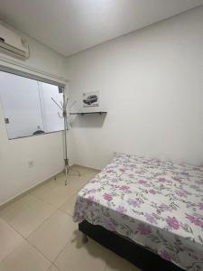 a bedroom with a bed and a window at GREAT HOUSE in Manaus