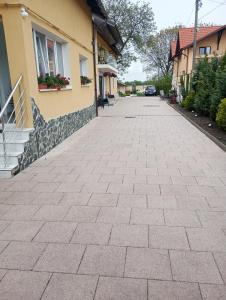 a brick driveway in front of a house at Izabella Guest House in Săcele