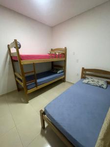 a bedroom with a bunk bed and a desk at GREAT HOUSE in Manaus
