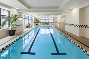a swimming pool with blue water in a building at CityLife Auckland in Auckland