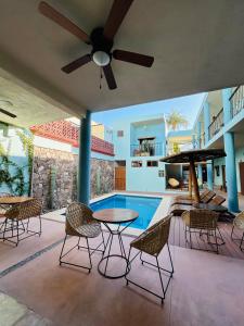 a patio with a table and chairs and a pool at Rosarito Hotel in Loreto