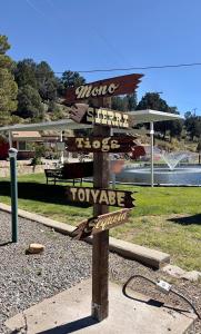 a sign with many signs on it in a park at Willow Springs Resort in Bridgeport