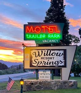 a sign for a motel trailer park with a window resort sprinklers at Willow Springs Resort in Bridgeport