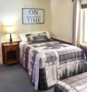 a bedroom with a bed and a table with a lamp at Willow Springs Resort in Bridgeport