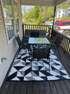 a patio with a table and chairs on a porch at Retreat to my Contemporary Home in Morgantown