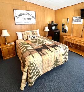 a hotel room with a bed and a tv at Willow Springs Resort in Bridgeport