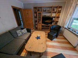 a living room with a couch and a coffee table at Haus Piratenperle - Hooksiel in Wangerland