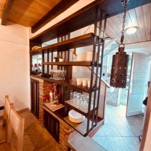 a kitchen with a shelf with dishes on it at USHUAIA MG in Ushuaia +6 photos