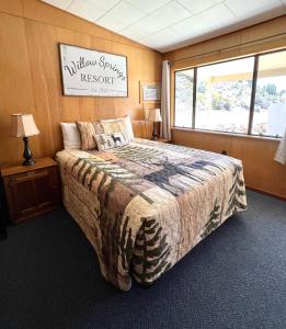 a bedroom with a bed and a sign on the wall at Willow Springs Resort in Bridgeport