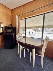 a dining room with a table and chairs and a window at Willow Springs Resort in Bridgeport