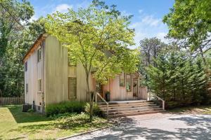 a house with stairs leading to the front door at Villa Sofia East Hampton - Exclusive Vacation Rental with Pool in Freetown