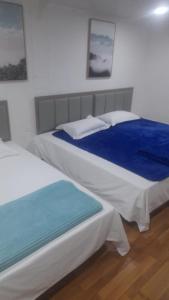 מיטה או מיטות בחדר ב-NLM HOTEL