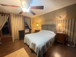 a bedroom with a bed and a ceiling fan at THE RED dragon in Niagara Falls