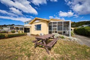 a picnic table in front of a house at Sea View Motel - Unit 8 in Kaikoura
