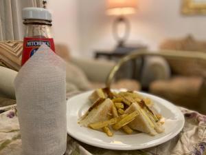 a plate of french fries and a bottle of water at E Lodge in Islamabad