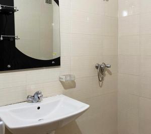 a bathroom with a white sink and a mirror at Charming house in Agadir