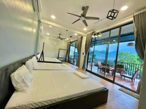 two beds in a bedroom with a view of the ocean at T House - Venuestay in Ba Vì