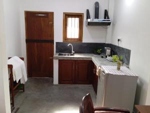a small kitchen with a sink and a refrigerator at Villa 39 Katunayake Airport transit villa in Katunayake