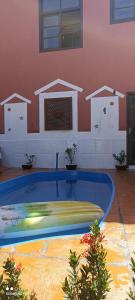 a swimming pool in a room with houses on the wall at Pousada Ray Sol - Centro Arraial d Ajuda in Porto Seguro