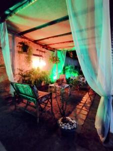 a patio with a green bench under a tent at Pousada Ray Sol - Centro Arraial d Ajuda in Porto Seguro