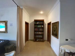 a hallway with a book shelf with books at E Lodge in Islamabad