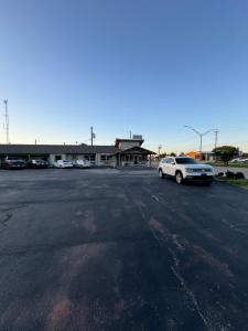 a parking lot with a car parked in front of a building at Economy Inn in Ada +8 photos