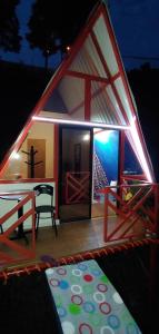a house with a lit up roof with a table at Finca buenos aires in Manizales