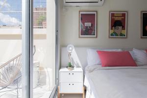 a bedroom with a white bed and a window at Segui 3900 'b' - Loft Palermo Chico in Buenos Aires